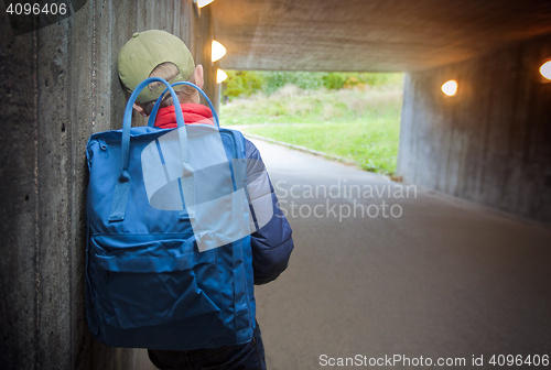 Image of School child walking in a dark subway