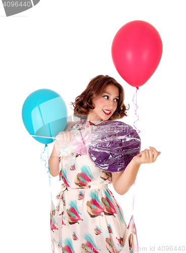 Image of Woman with balloons and lollipop.