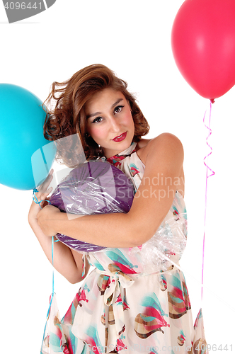 Image of Beautiful woman holding balloons.