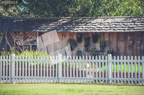Image of White picket fence in a garden