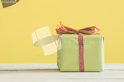 Image of Green gift with a red and orange ribbon