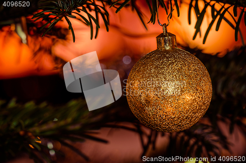 Image of Golden Christmas bauble with glittering lights