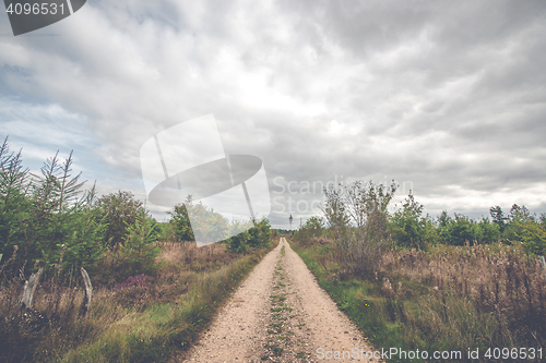 Image of Dark clouds over a countryside trail