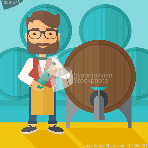 Image of Wine maker inspecting wine from barrel.