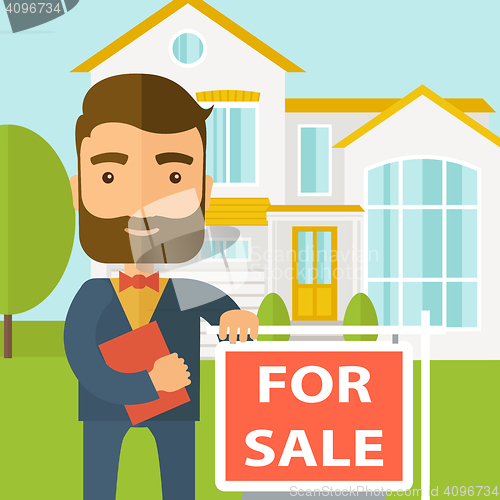 Image of Real estate agent standing beside the for sale placard.