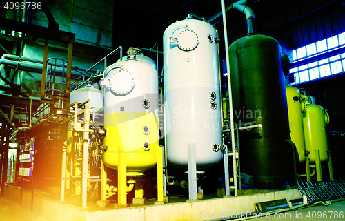 Image of gauges connected with many metallic pipes, interior of water tre