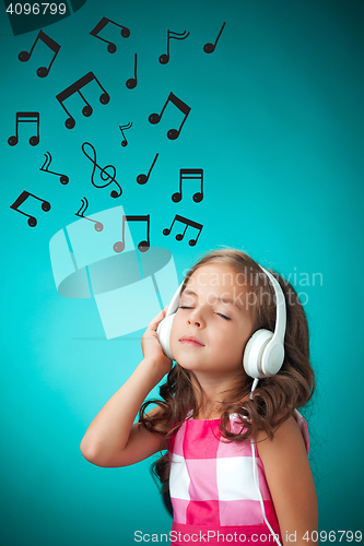 Image of The cute cheerful little girl on orange background