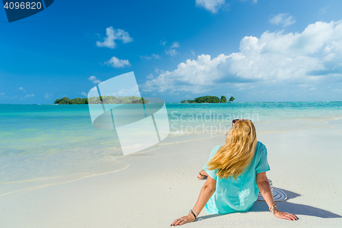 Image of portrait of young pretty woman looking to the ocean 