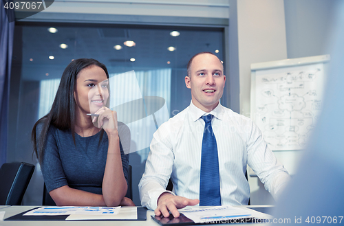 Image of smiling business people meeting in office