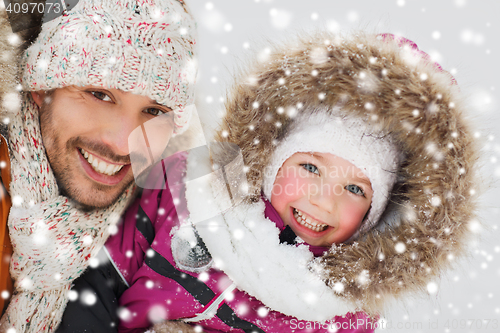 Image of happy family in winter clothes outdoors