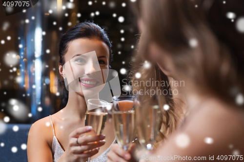 Image of happy women with champagne glasses at night club