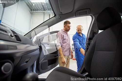 Image of auto mechanic and man at car shop