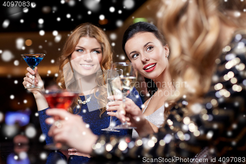 Image of happy women with drinks at night club
