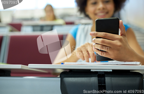 Image of close up of african student with smartphone