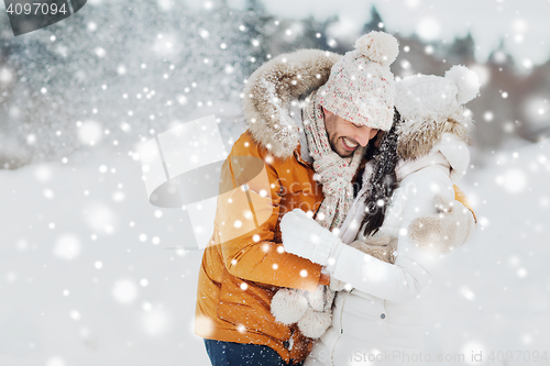 Image of happy couple hugging and laughing in winter