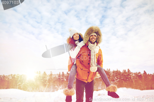 Image of happy couple having fun over winter background