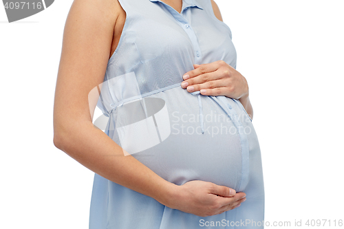 Image of close up of pregnant woman touching her big belly