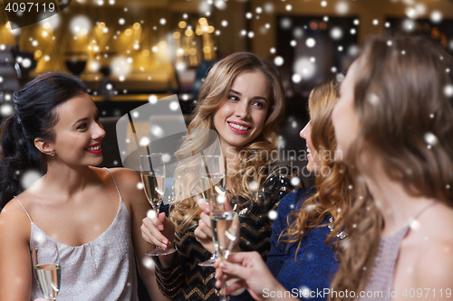 Image of happy women with champagne glasses at night club