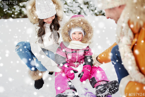 Image of happy family with sled walking in winter outdoors