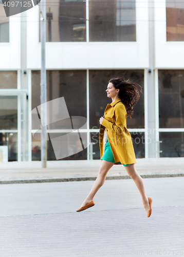 Image of happy young woman or teenage girl on city street