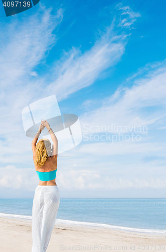 Image of portrait of young pretty woman looking to the ocean 