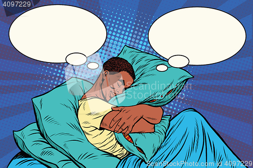 Image of Dreamer man in bed hugging a pillow