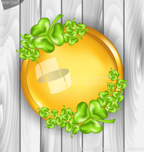 Image of Golden coin with shamrocks. St. Patrick\'s day symbol, wooden tex