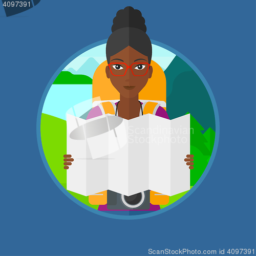 Image of Traveler with backpack looking at map.