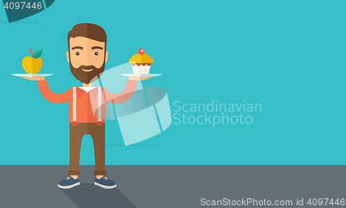 Image of Man carries with his two hands cupcake and apple.