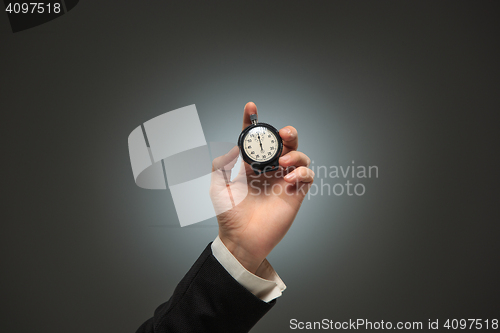 Image of hand holding a stopwatch against a white background