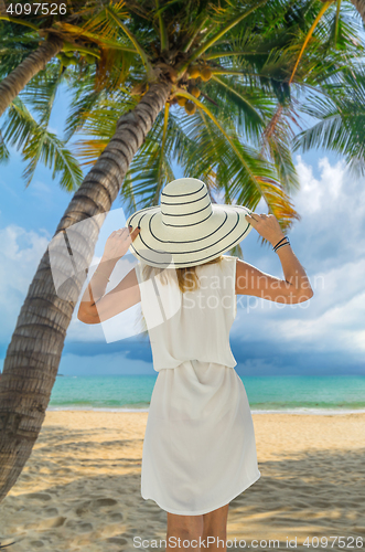 Image of portrait of young pretty woman looking to the ocean 