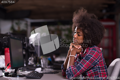 Image of a young African American woman feels tired in the modern office