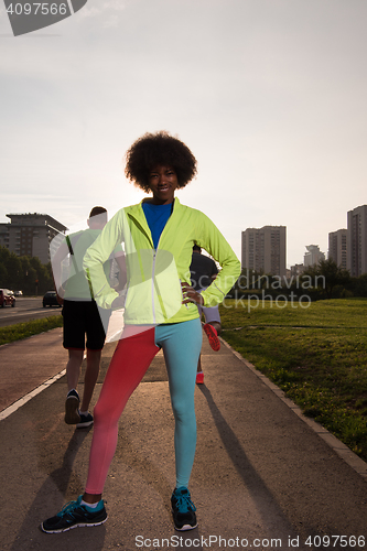 Image of Portrait of sporty young african american woman running outdoors