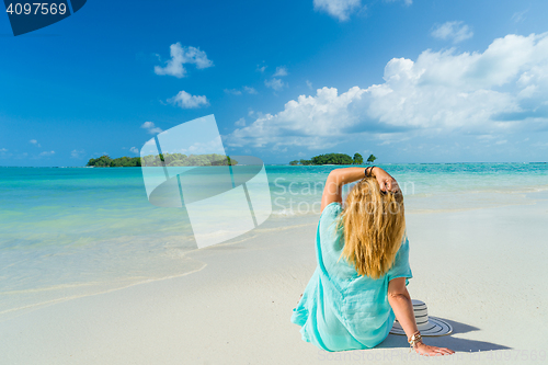 Image of portrait of young pretty woman looking to the ocean 