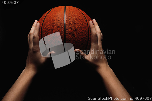 Image of Basketball ball in male hands