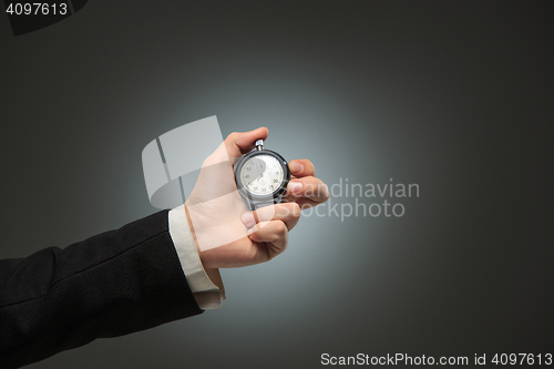 Image of hand holding a stopwatch against a white background