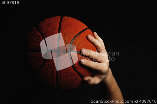 Image of Basketball ball in male hands