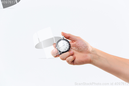 Image of hand holding a stopwatch against a white background