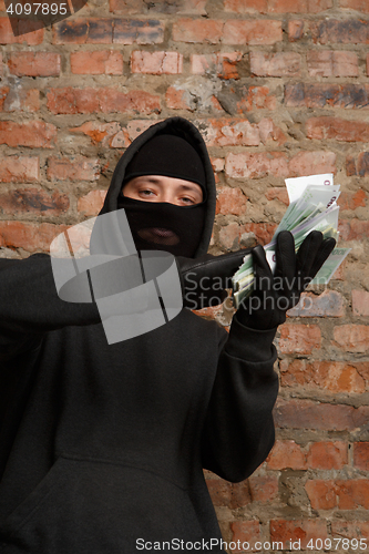 Image of Burglar with packet of money