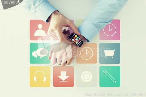 Image of hands with application icons on smart watch