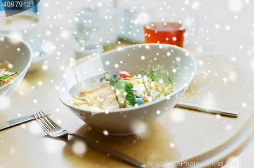 Image of close up of pasta in bowl on table at restaurant