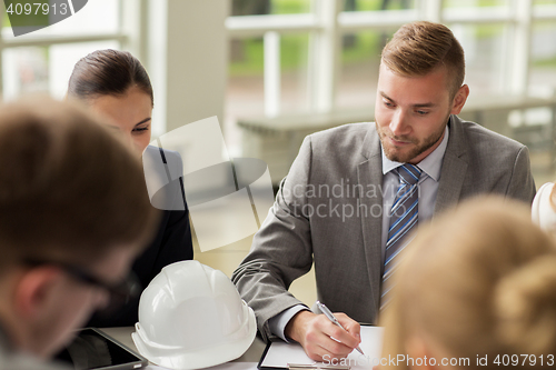 Image of architects with helmet and clipboard at office