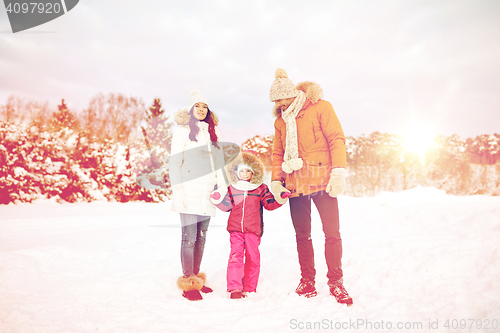 Image of happy family with child in winter clothes outdoors