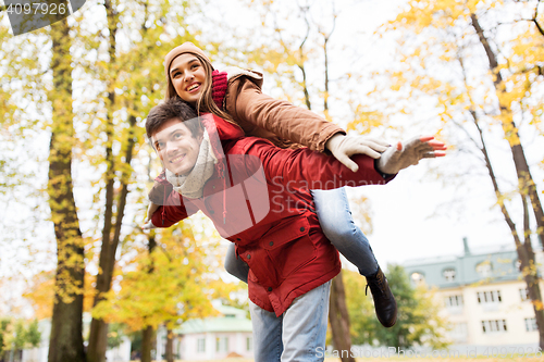 Image of happy young couple having fun in autumn park