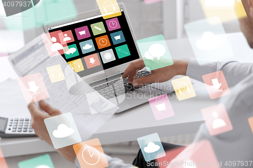 Image of businessman with laptop computer working at office