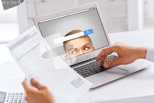 Image of businessman with laptop computer working at office