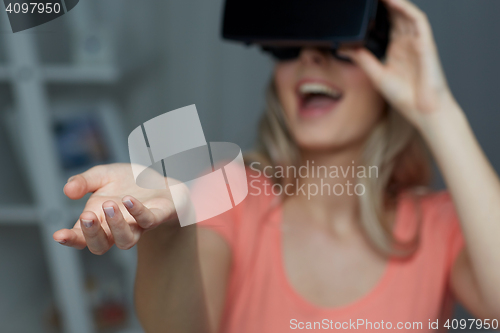 Image of happy woman in virtual reality headset or glasses