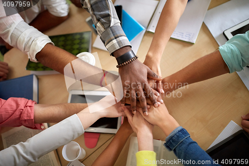 Image of close up of international students hands on top