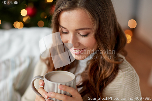 Image of close up of woman drinking cocoa at christmas