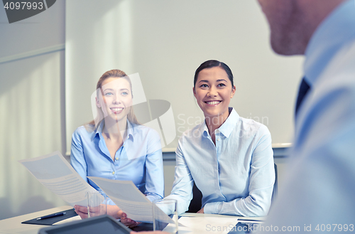 Image of smiling businesswomen meeting in office